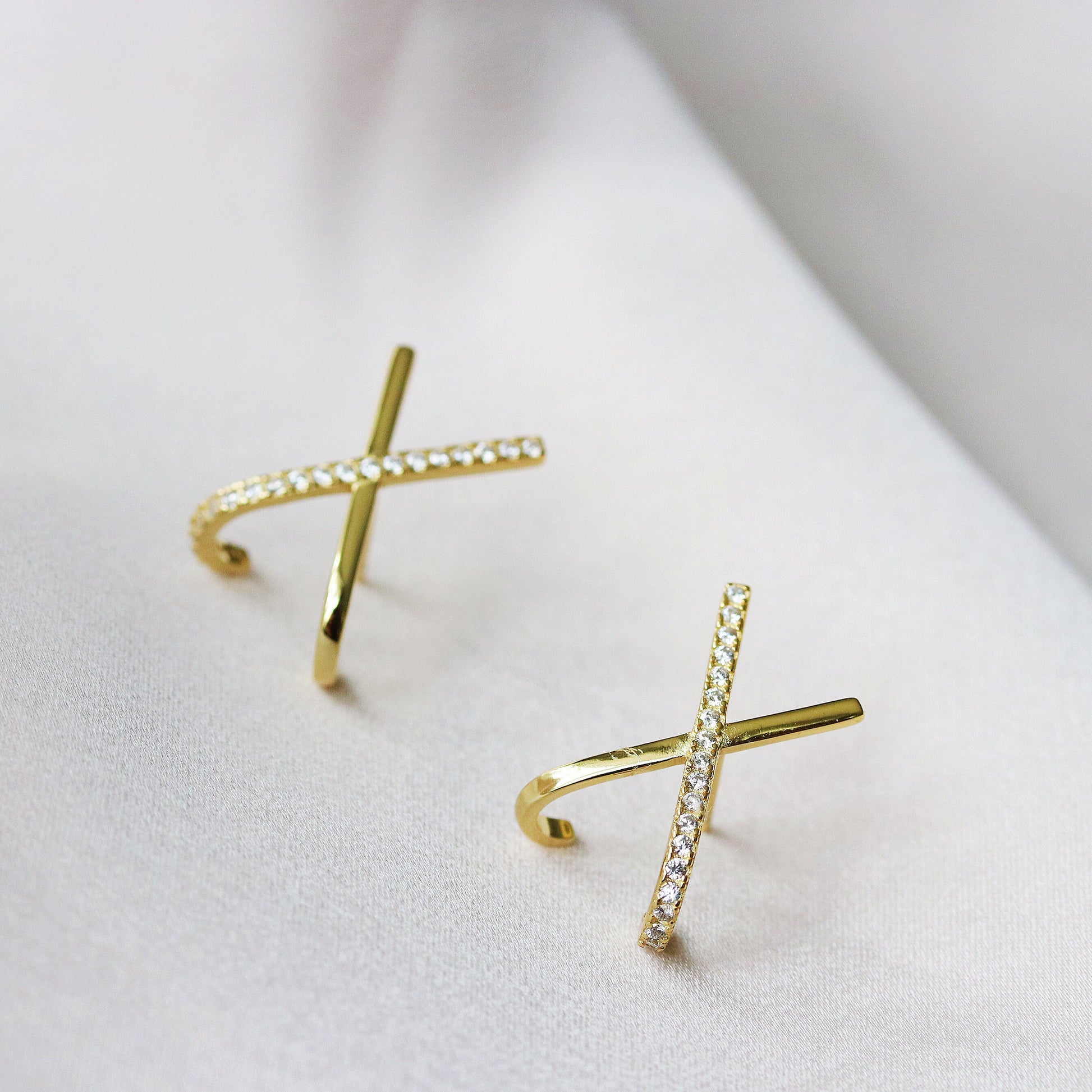 Shan&Co's Silver /Gold Cross Pave CZ Stud Earrings featuring a stunning pave setting of crystal zirconia stones in a cross X letter design, crafted from high-quality sterling silver for an elegant and symbolic look