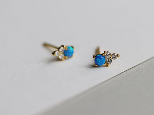 Gold Vermeil/Sterling Silver Opal and Crystal Trio Stud Earrings featuring a dazzling blue opal at the center, accented with sparkling cubic zirconia crystals. These lightweight and elegant earrings offer a luxurious finish, perfect for both casual and special occasions.