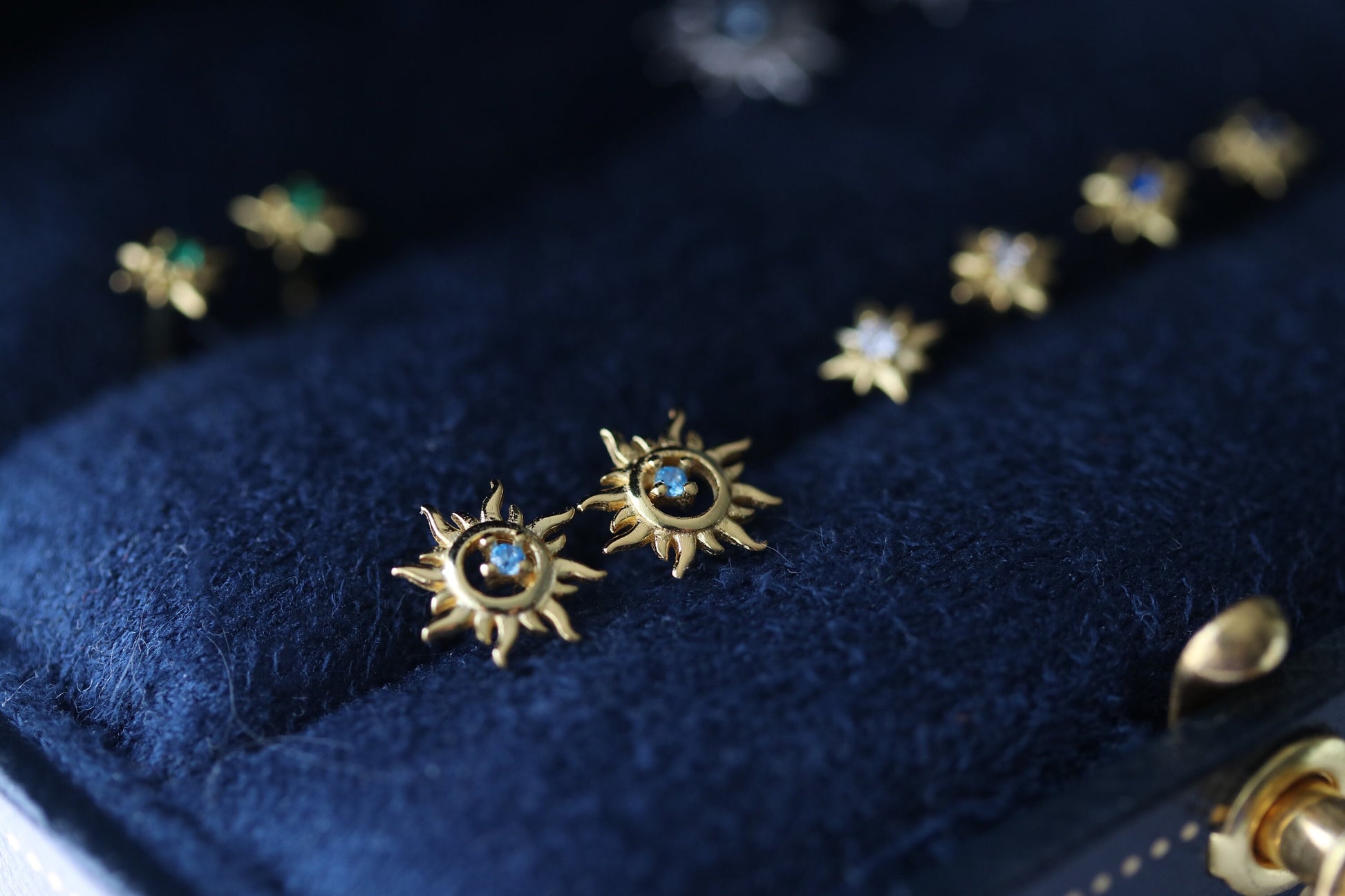 Shan&Co's Sterling Silver/Gold Vermeil Starburst Stud Earrings, featuring a radiant starburst design, paired with Blue Opal Sunburst Studs for a celestial-inspired look. Crafted in high-quality sterling silver or gold vermeil.