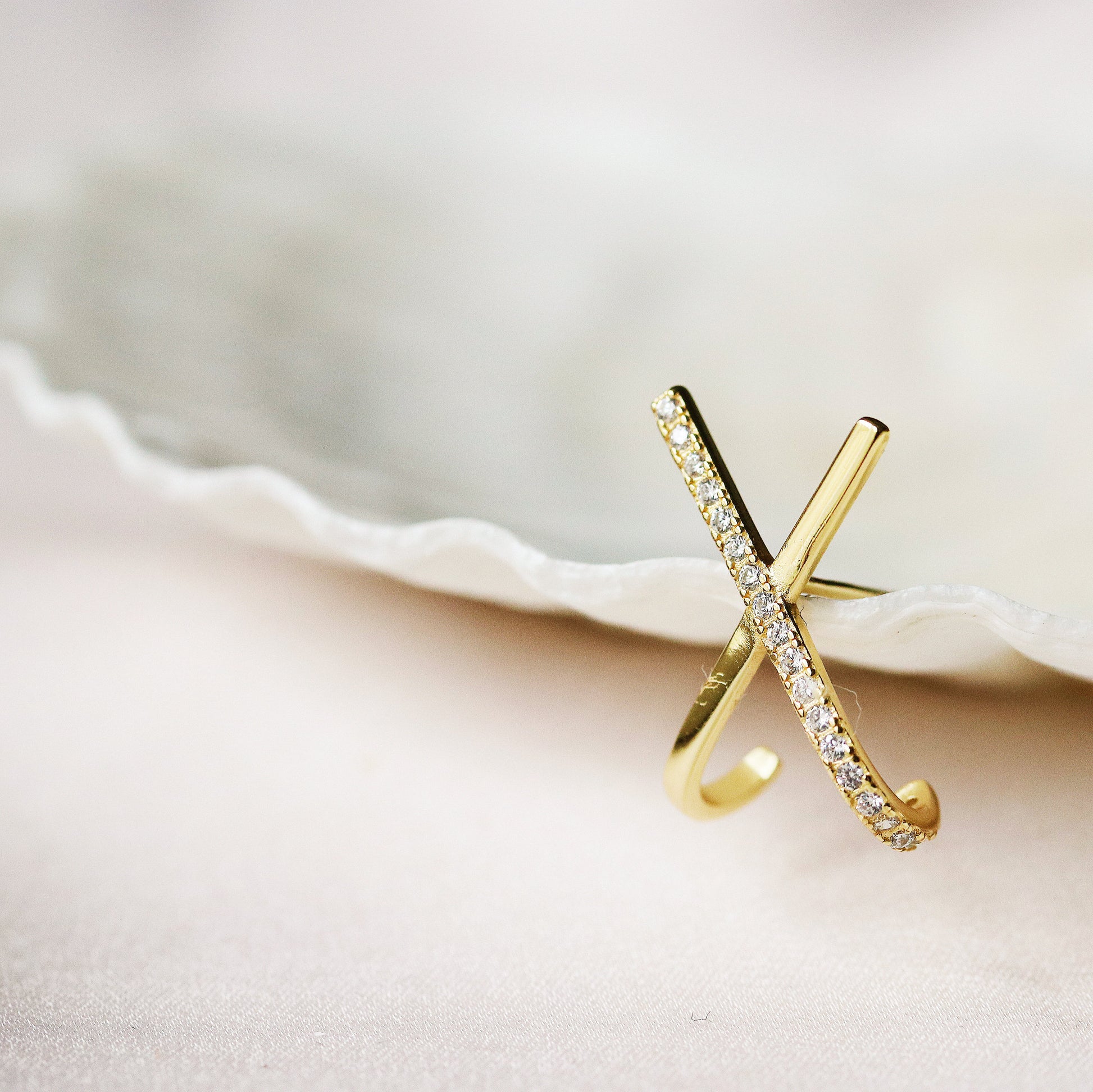 Shan&Co's Silver /Gold Cross Pave CZ Stud Earrings featuring a stunning pave setting of crystal zirconia stones in a cross X letter design, crafted from high-quality sterling silver for an elegant and symbolic look