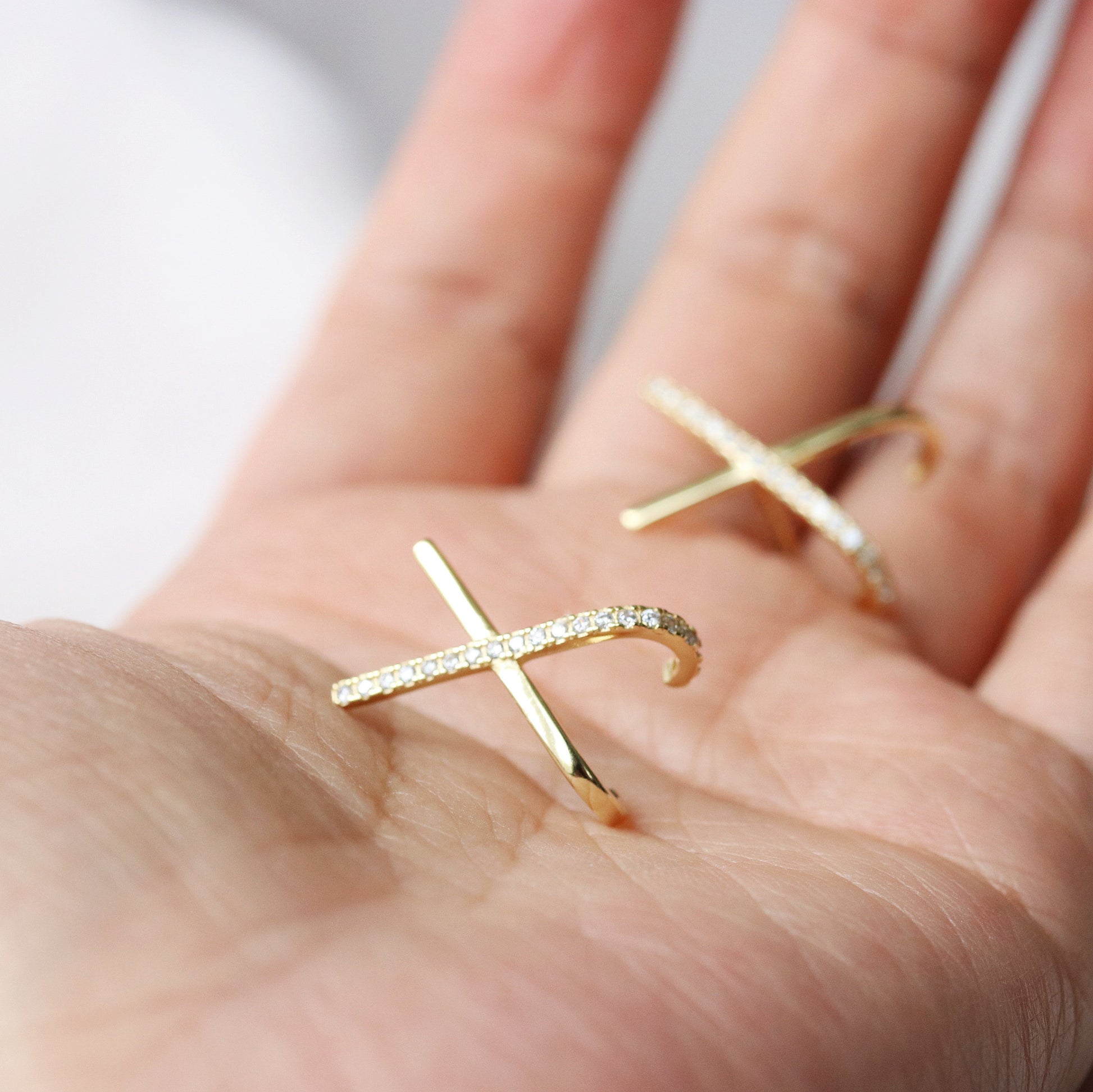 Shan&Co's Silver /Gold Cross Pave CZ Stud Earrings featuring a stunning pave setting of crystal zirconia stones in a cross X letter design, crafted from high-quality sterling silver for an elegant and symbolic look