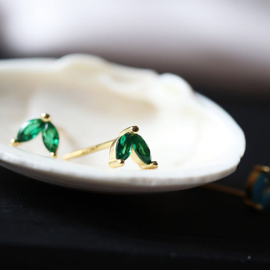  Shan&Co's Gold Emerald CZ Duo Marquise Earrings featuring marquise-cut crystal zirconia accents, crafted in gold vermeil with nature-inspired leaf and flower designs for an elegant look.