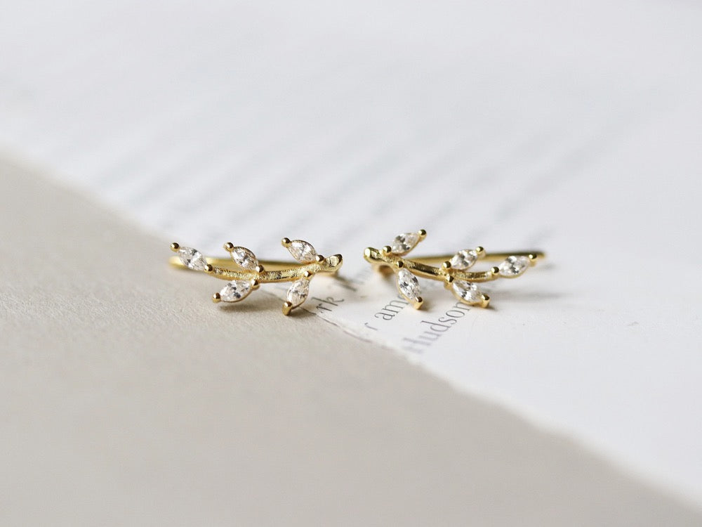 Gold Vermeil/Sterling Silver Leaf Crystal Stud Earrings featuring a delicate leaf design adorned with sparkling crystals. These lightweight earrings offer a luxurious finish, perfect for everyday elegance or special occasions.