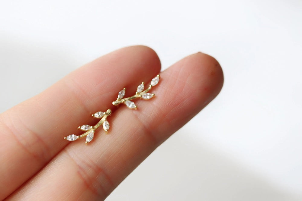 Gold Vermeil/Sterling Silver Leaf Crystal Stud Earrings featuring a delicate leaf design adorned with sparkling crystals. These lightweight earrings offer a luxurious finish, perfect for everyday elegance or special occasions.