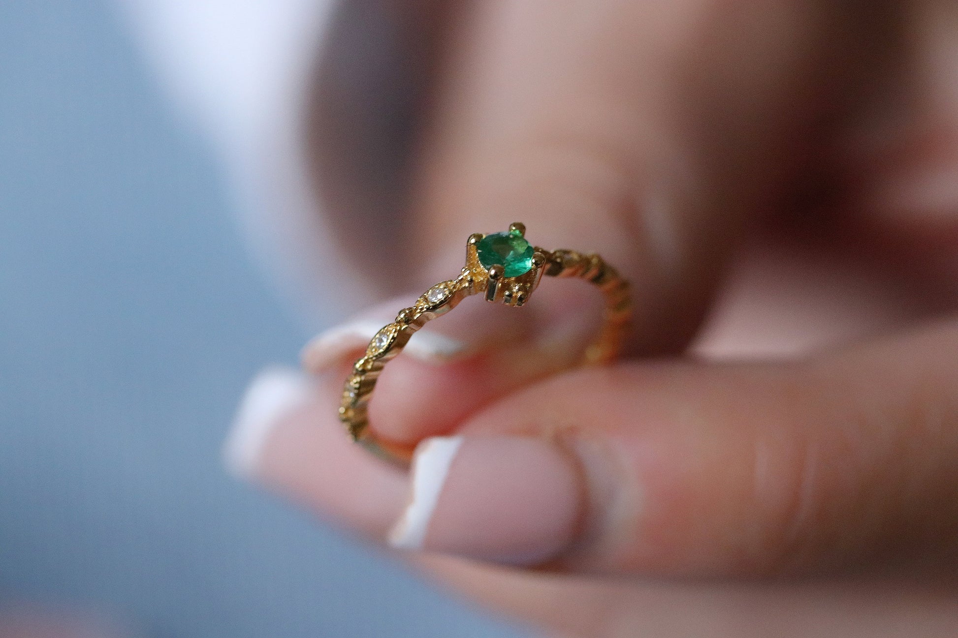 Gold Plated Emerald Ring featuring an adjustable band with a vibrant green cubic zirconia crystal, designed for stacking. A dainty and vintage-inspired piece that blends classic charm with modern versatility.