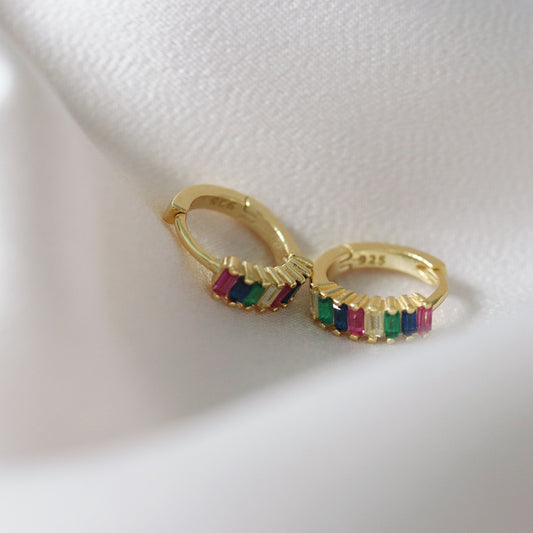 Shan&Co's Gold Plated Rainbow Baguette Hoop Earrings featuring vibrant rainbow-colored baguette crystals set in luxurious gold plating, perfect for adding a bold and colorful touch to any outfit