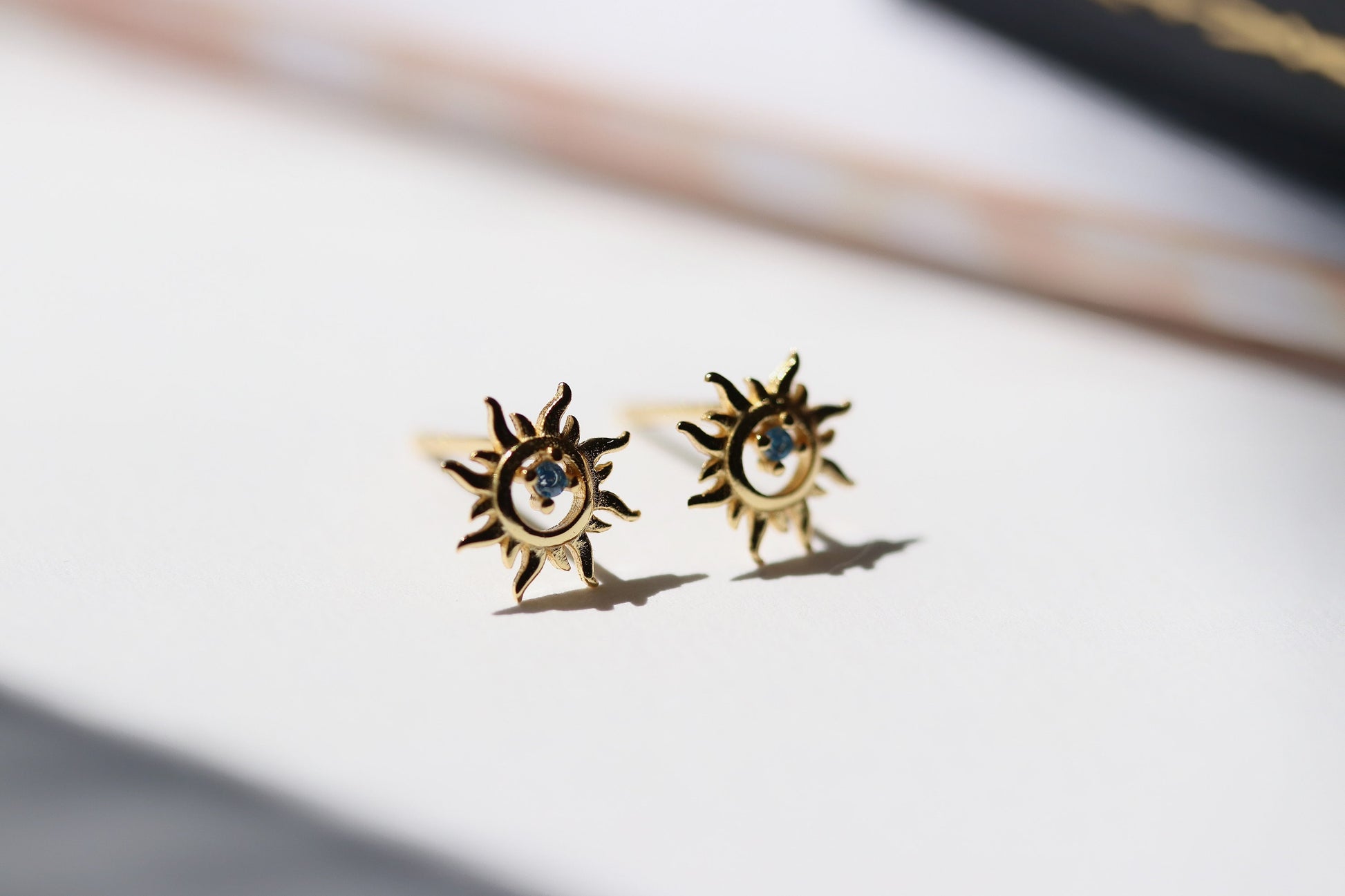 Shan&Co's Sterling Silver/Gold Vermeil Starburst Stud Earrings, featuring a radiant starburst design, paired with Blue Opal Sunburst Studs for a celestial-inspired look. Crafted in high-quality sterling silver or gold vermeil.