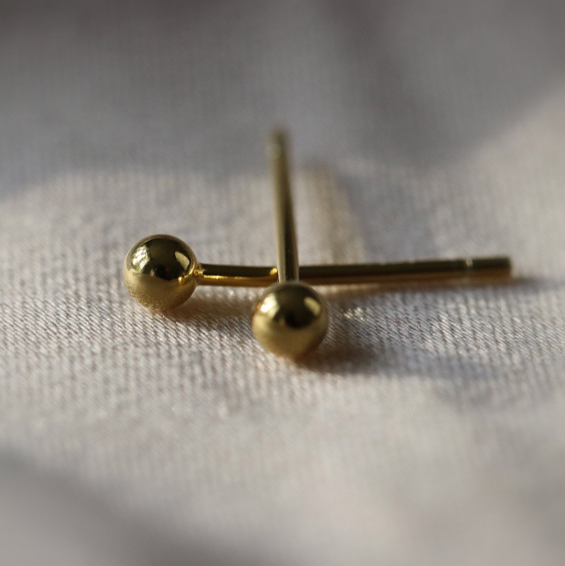 Shan&Co's Gold/Silver Tiny Ball Studs Earrings featuring a minimalist dot design, crafted from high-quality gold or silver, perfect for everyday wear and adding a subtle touch of elegance.