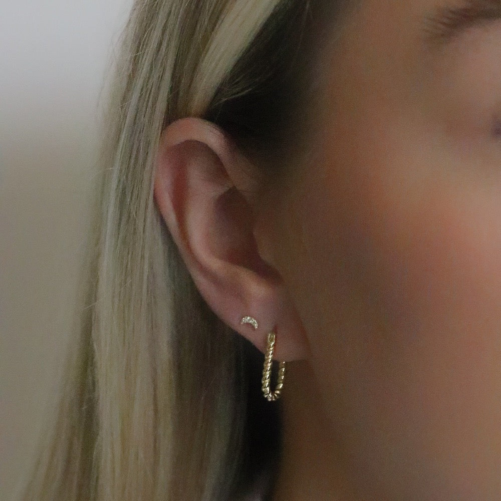 Shan&Co's Sterling Silver and Gold Twisted Oval Hoops Earrings featuring a beautifully crafted twisted design that combines sterling silver and gold for a sophisticated two-tone effect, perfect for adding elegance to any outfit.