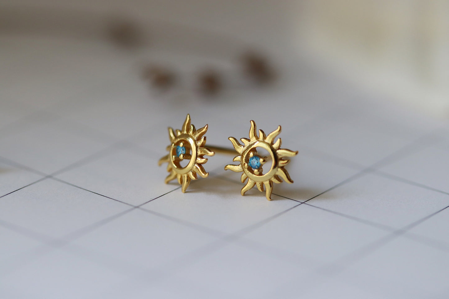 Shan&Co's Sterling Silver/Gold Vermeil Starburst Stud Earrings, featuring a radiant starburst design, paired with Blue Opal Sunburst Studs for a celestial-inspired look. Crafted in high-quality sterling silver or gold vermeil.