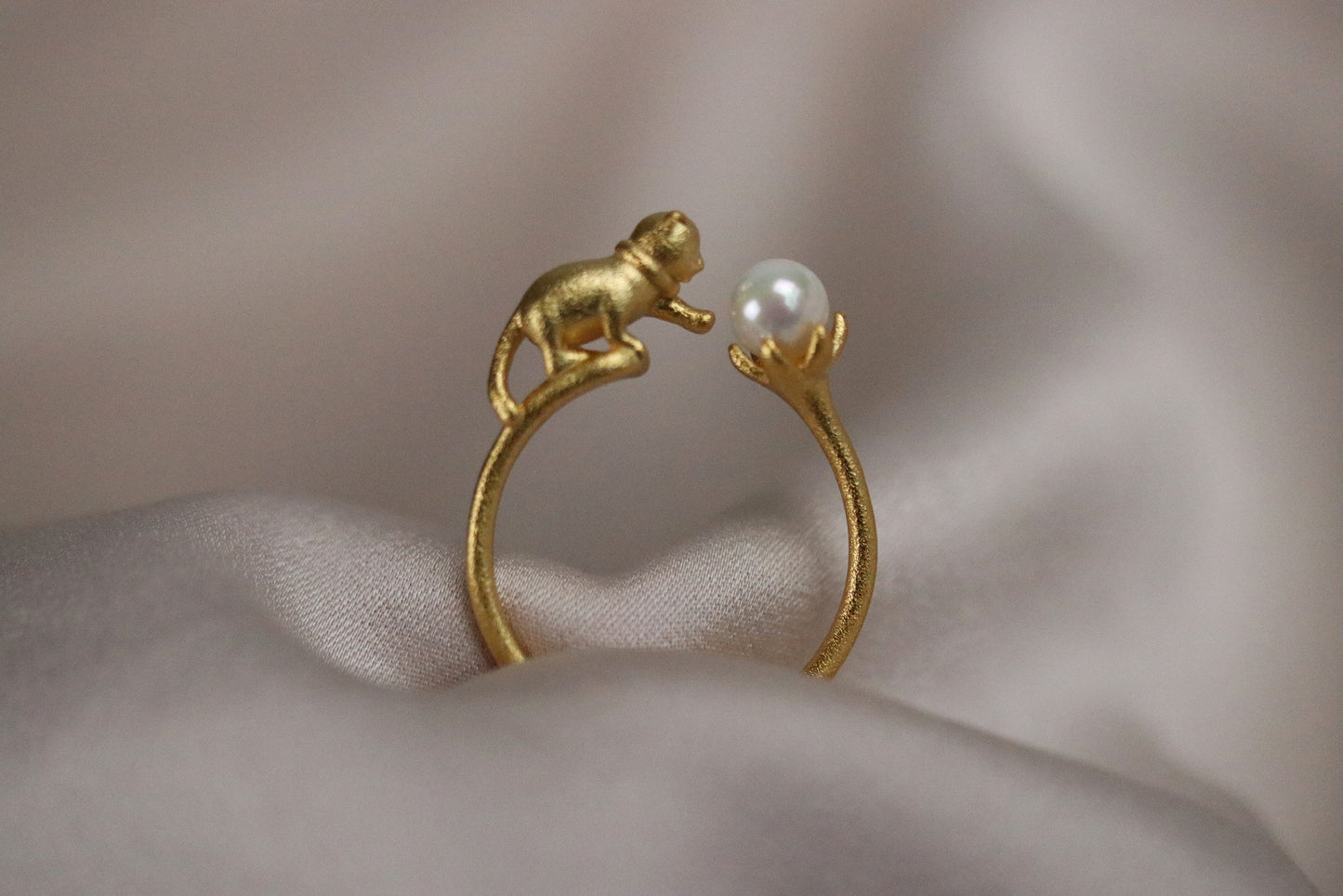 Gold Vermeil Cat Pearl Open Statement Ring featuring a playful cat design that wraps around the finger, adorned with a natural pearl. Adjustable for comfort, this unique piece adds charm and sophistication to any outfit.