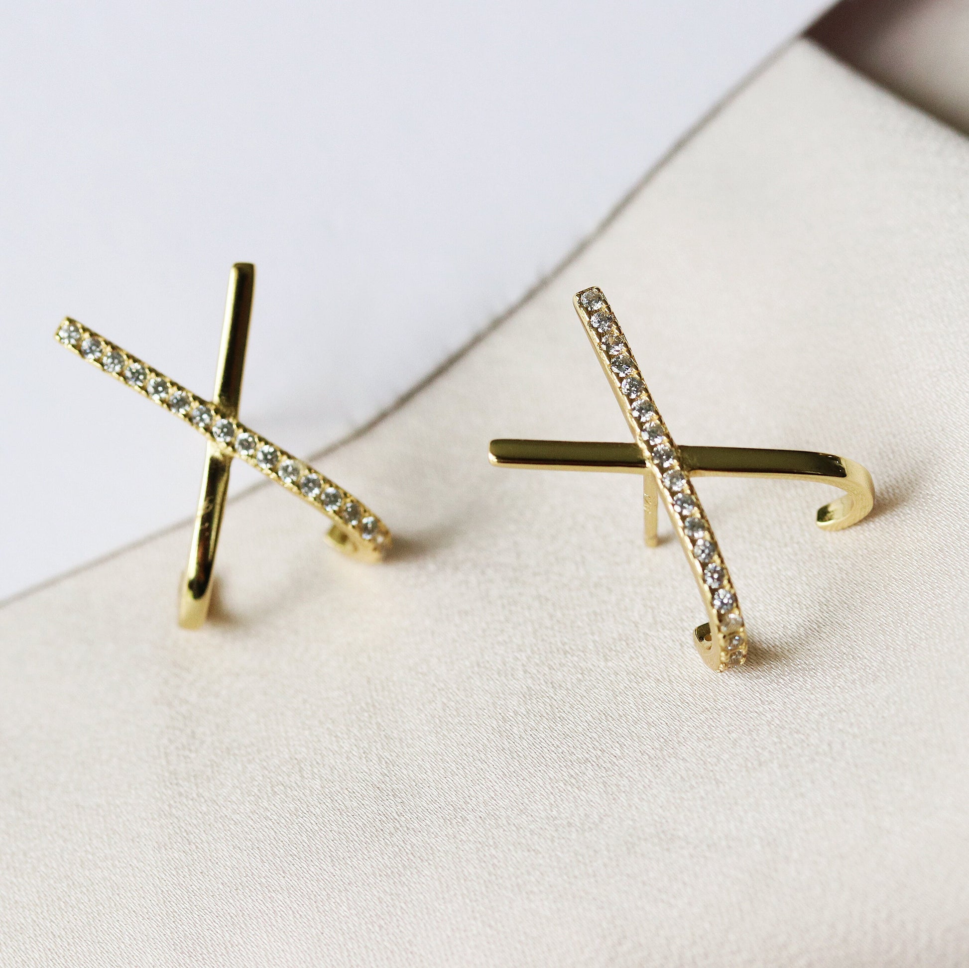 Shan&Co's Silver /Gold Cross Pave CZ Stud Earrings featuring a stunning pave setting of crystal zirconia stones in a cross X letter design, crafted from high-quality sterling silver for an elegant and symbolic look