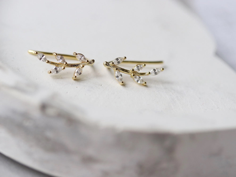 Gold Vermeil/Sterling Silver Leaf Crystal Stud Earrings featuring a delicate leaf design adorned with sparkling crystals. These lightweight earrings offer a luxurious finish, perfect for everyday elegance or special occasions.