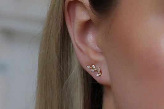 Gold Vermeil/Sterling Silver Leaf Crystal Stud Earrings featuring a delicate leaf design adorned with sparkling crystals. These lightweight earrings offer a luxurious finish, perfect for everyday elegance or special occasions.