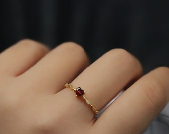 Gold Vermeil Red Gem Heart Crystal Ring with a vibrant heart-shaped red gemstone and sparkling crystal accents.