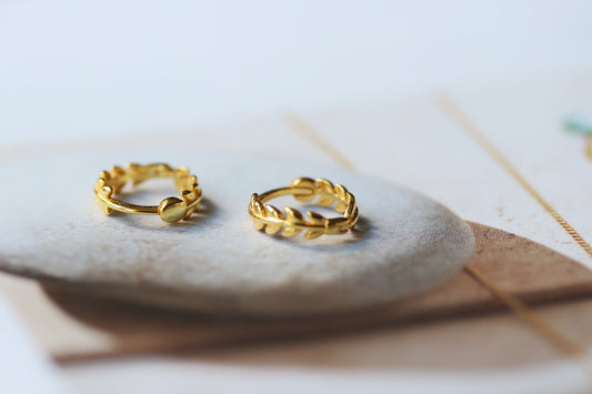 Shan&Co's Sterling Silver/Gold Vermeil Tiny Olive Leaves Hoop Earrings, featuring a delicate olive leaf design, perfect for stacking or wearing alone for a minimalist, nature-inspired look.