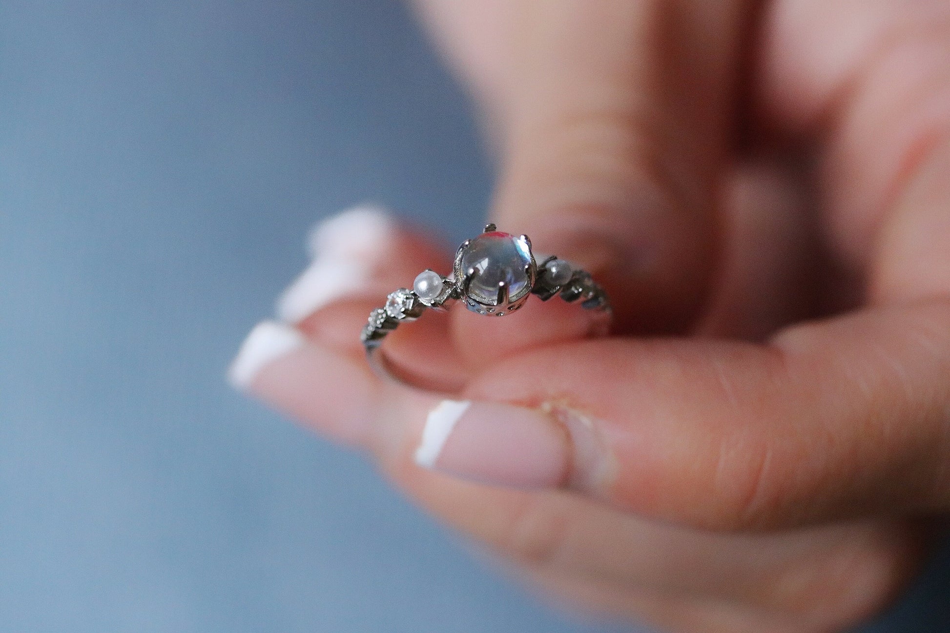 Sterling Silver Natural Moonstone Ring featuring a genuine moonstone center with a spectrum of shifting colors, set in a durable sterling silver band for a touch of elegance.