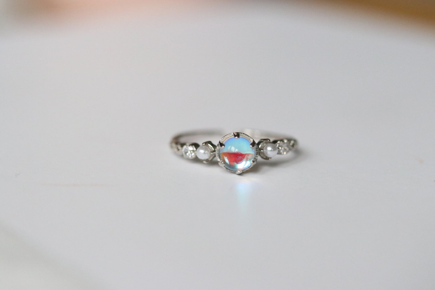 Sterling Silver Natural Moonstone Ring featuring a genuine moonstone center with a spectrum of shifting colors, set in a durable sterling silver band for a touch of elegance.