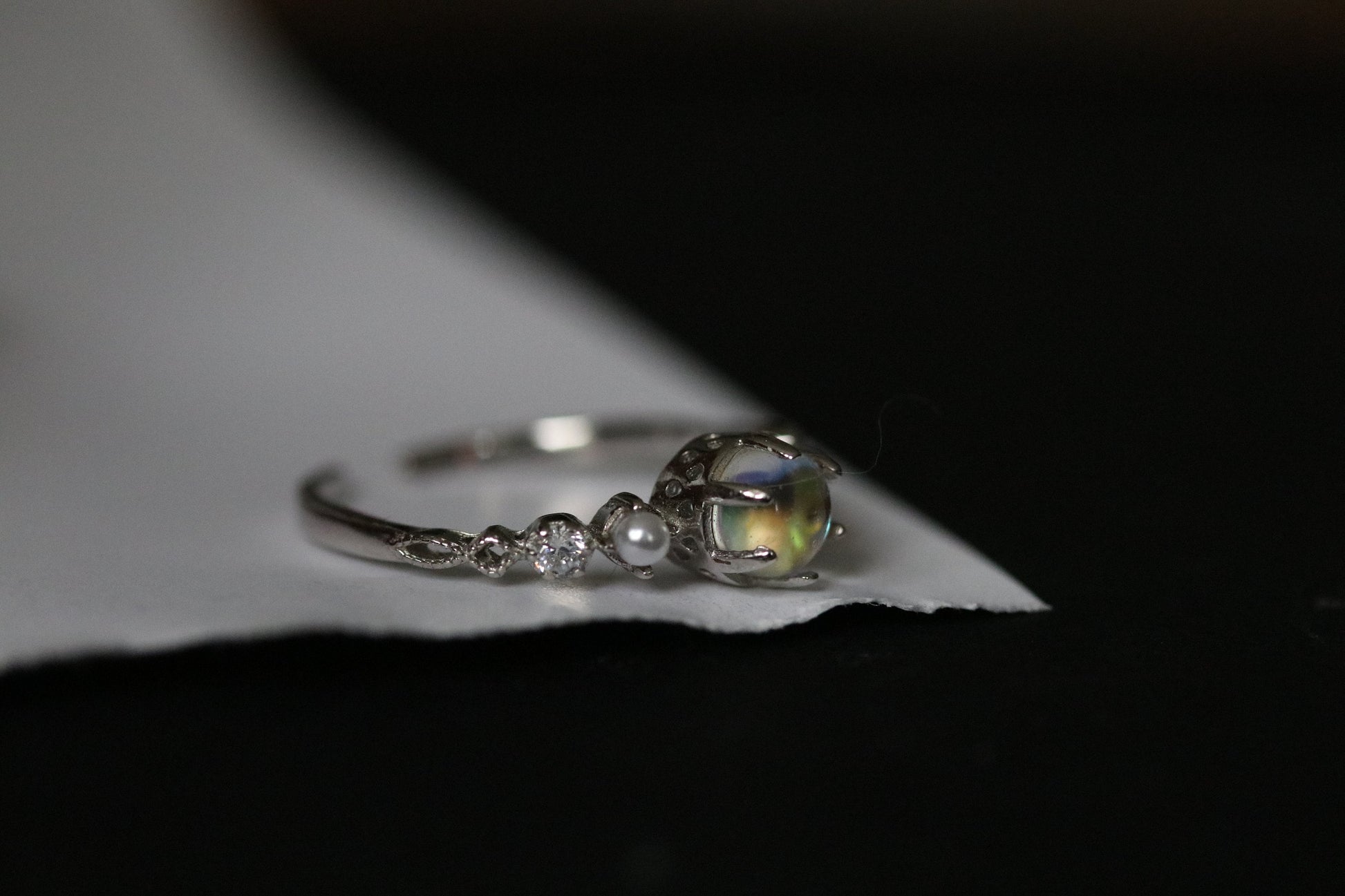 Sterling Silver Natural Moonstone Ring featuring a genuine moonstone center with a spectrum of shifting colors, set in a durable sterling silver band for a touch of elegance.