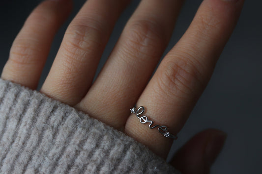 Sterling Silver Love Script Ring featuring an open-band design with "Love" in delicate script, minimalist and elegant.