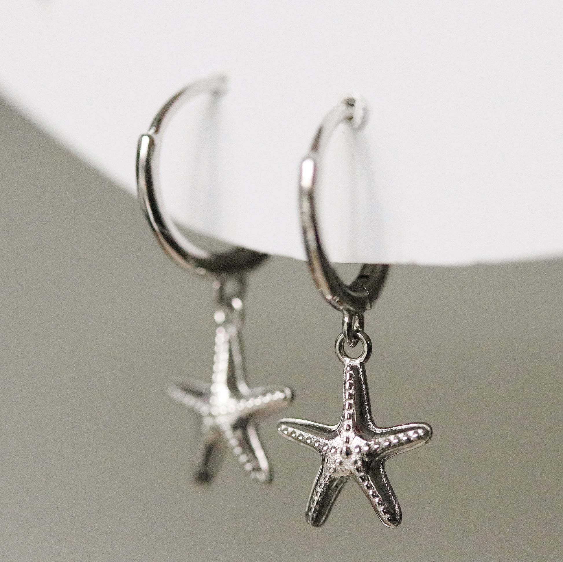 Sterling Silver/Gold Vermeil Starfish Dangle Hoop Earrings featuring a delicate starfish charm hanging from a sleek hoop, available in sterling silver or gold vermeil. These elegant earrings capture the essence of the ocean and add a unique touch to your look. Perfect for beach lovers, these starfish hanging huggies are versatile for both casual and formal occasions.