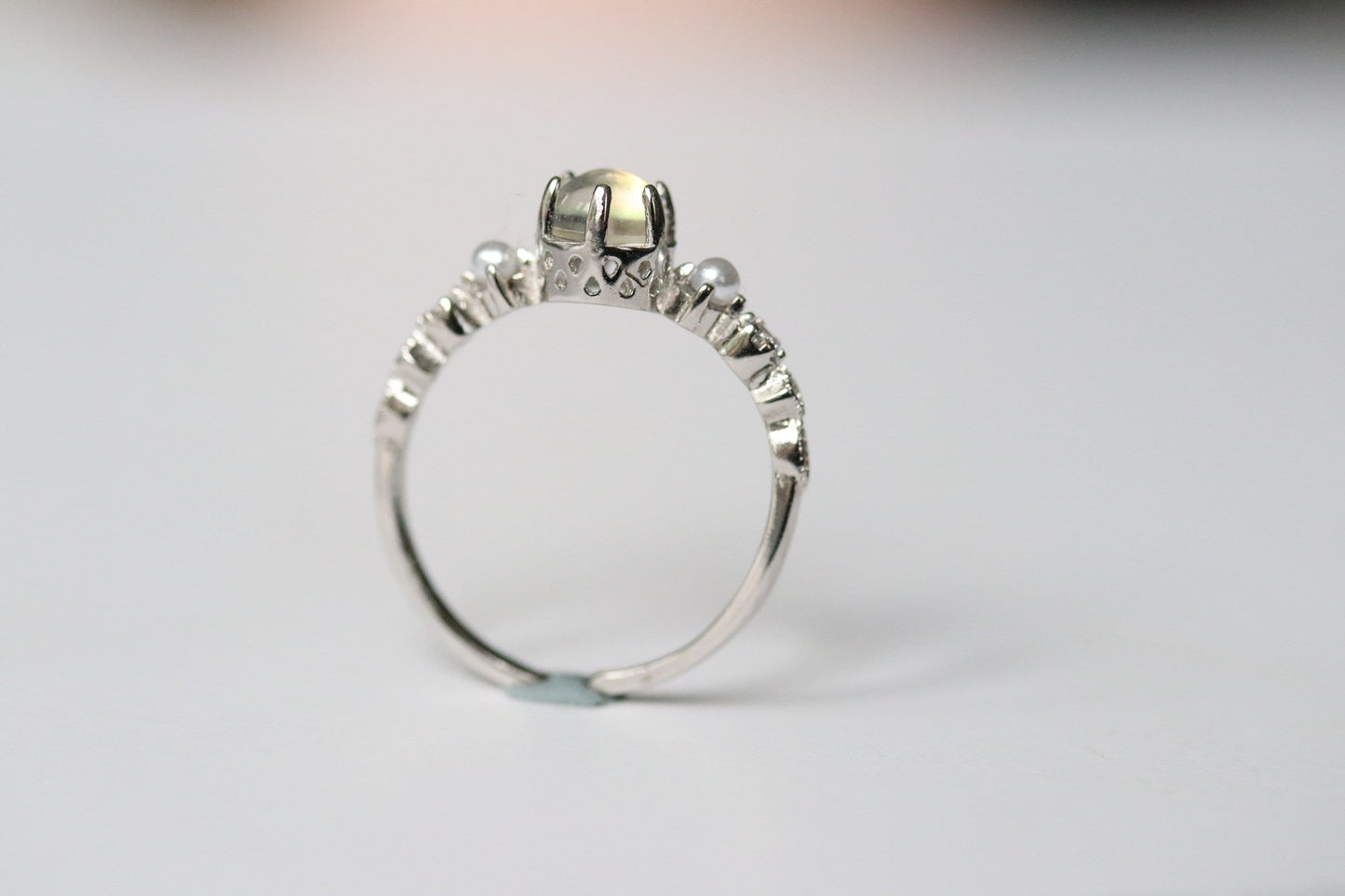 Sterling Silver Natural Moonstone Ring featuring a genuine moonstone center with a spectrum of shifting colors, set in a durable sterling silver band for a touch of elegance.