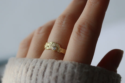 Textured sterling silver or gold vermeil ring with a bezel-set diamond, showcasing a rustic organic band in a minimalist design.